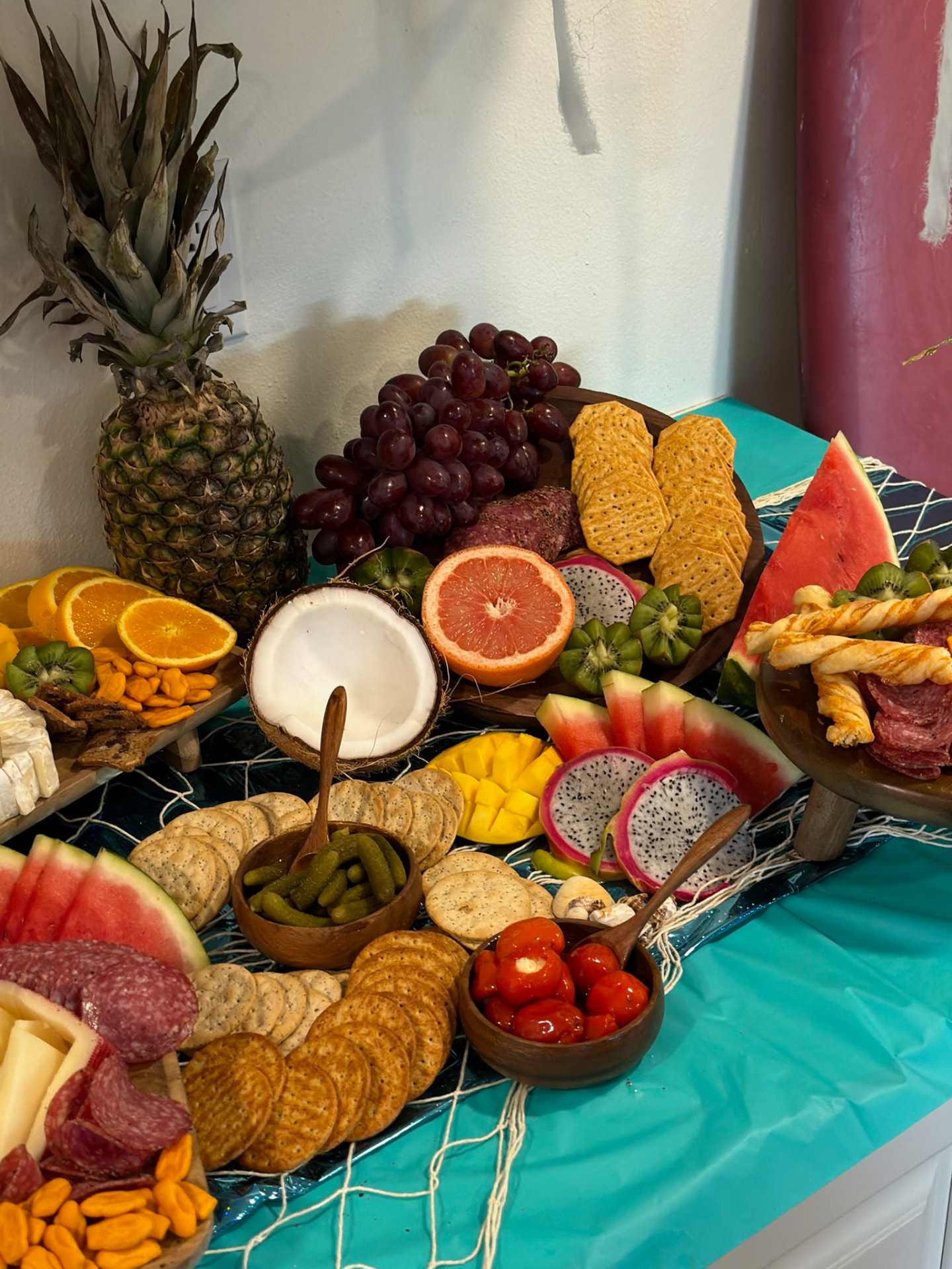 Tropical grazing table with pineapple, coconut, dragon fruit and charcuterie